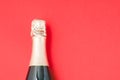 Champagne glasses and bottle on red background, space for text. Christmas decoration Royalty Free Stock Photo