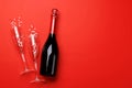 Champagne glasses and bottle on a red background with text space Royalty Free Stock Photo