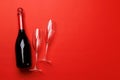 Champagne glasses and bottle on a red background with text space Royalty Free Stock Photo