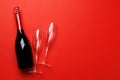 Champagne glasses and bottle on a red background with text space Royalty Free Stock Photo