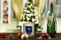 Champagne in glasses and in a bottle and toys on the Christmas tree on the background of bokeh. Royalty Free Stock Photo