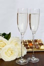 Champagne Glasses, Box of Chocolate and Bunch of White Roses Royalty Free Stock Photo