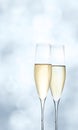 Champagne glasses on bright blue background Royalty Free Stock Photo