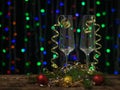 Champagne glasses and Golden ribbons on a background of multicolored bokeh. Royalty Free Stock Photo