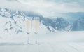 Champagne in glasses and landscape of mountains on background
