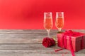 Champagne glasses, red gift box and red roses Royalty Free Stock Photo