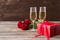 Champagne glasses, red gift box and red roses Royalty Free Stock Photo