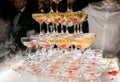 Champagne glasses standing in a tower at the wedding party. Champagne glass pyramid. Pyramid of glasses of wine, champagne, tower