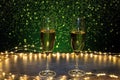 Champagne glasses surrounded by lights on a background of flashes Royalty Free Stock Photo