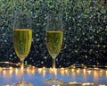 Champagne glasses surrounded by lights on a background of flashes Royalty Free Stock Photo