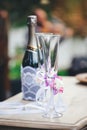 Champagne glasses with a wedding decoration and a bottle of champagn