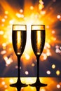 Champagne glassess against sparkler background