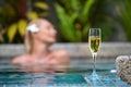 Champagne near swimming pool on a background of a beautiful woman