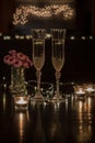 Champagne and pink flowers on dark table for romantic dinner date night heart bokeh