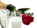 Champagne poring into glasses with roses Royalty Free Stock Photo