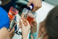 Champagne is poured into plastic glasses