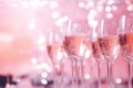 Champagne or rose wine in many elegant glasses on festive pink background. Royalty Free Stock Photo