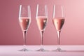 Champagne or rose wine in many elegant glasses on festive pink background. Royalty Free Stock Photo