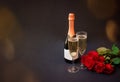 Champagne and roses on dark background. Greeting card with space for your text Royalty Free Stock Photo