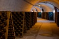 Champagne sparkling wine production in bottles in racks in underground cellar, Reims, Champagne, France Royalty Free Stock Photo