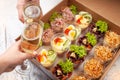 Champagne, tartlets, seafood salads. Cardboard box with food with home delivery. Gift for holiday, party, family dinner. Catering