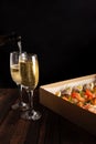 Champagne, tartlets, seafood salads. Cardboard box with food with home delivery. Gift for holiday, party, family dinner. Catering