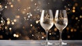 Champagne wine glasses flutes with golden bubbles on gold silver light bokeh background
