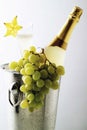 Champagner bottle and grape in ice bucket. Royalty Free Stock Photo