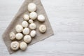 Champignon mushrooms over white wooden surface, top view. From above, overhead. Royalty Free Stock Photo