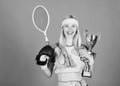 Champion concept. Girl sport instructor hold golden goblet of winner or champion. Woman good in tennis jumping boxing