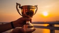 Champion with a Golden Cup at Sunset - Man Holding Trophy Royalty Free Stock Photo