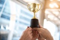 Champion golden trophy for winner with sport player hands in sport stadium background. Success and achievement concept. Sport and Royalty Free Stock Photo