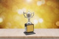 Champion trophy placed on wooden table. Royalty Free Stock Photo