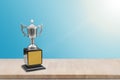 Champion trophy placed on wooden table. Royalty Free Stock Photo