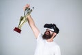 Championship online. Man bearded hipster vr headset holds golden goblet. Feel victory in virtual reality games. Achieve