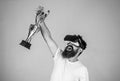 Championship online. Man bearded hipster vr headset holds golden goblet. Feel victory in virtual reality games. Achieve