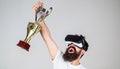 Championship online. Man bearded hipster vr headset holds golden goblet. Man winner virtual competition. Feel victory in