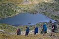 Hikers walk over the lakes called Lacs Robert in Belledonne mountain range