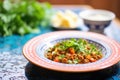 chana masala with parsley, side view on a colorful plate