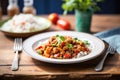 chana masala on a plate with fork and knife