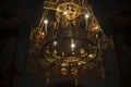 Chandelier in church. Golden chandelier in dark temple. Vintage interior