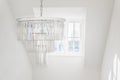 Chandelier hanging in front of dormer window