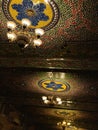 Chandelier at an old palace with glasswork on the ceiling