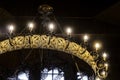 Chandelier in Russian Orthodox Church with crucifix and electric lamps