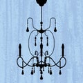 Chandelier on a scratched blue wallpaper