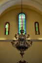 Antique chandelier symetric in Church Window colorfull