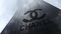 Chanel logo on a skyscraper facade reflecting clouds. Editorial 3D rendering