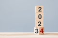 2023 chang to 2024 wooden cube blocks on table background. Resolution, plan, review, goal, start, end year and New Year holiday