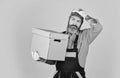 Change is in the air. bearded loader in uniform. Cardboard boxes - moving to a new house. purchase of new habitation or Royalty Free Stock Photo