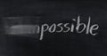 Change impossible to possible on blackboard Royalty Free Stock Photo